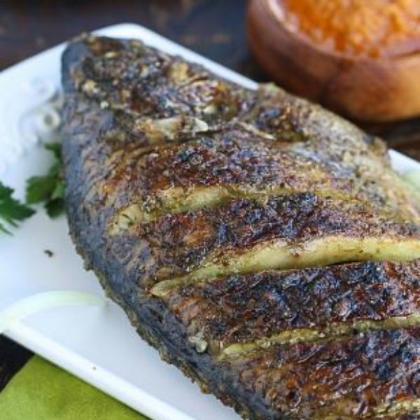 Whole peppered grilled Tilapia fish with any choice of rice Flavor