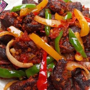 Asun ( Spicy smoked Goatmeat) with cucumber & tomato salad