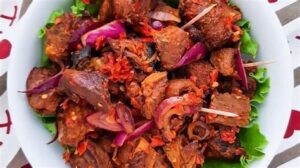 Asun ( Spicy smoked Goatmeat) with cucumber & tomato salad - Image 2